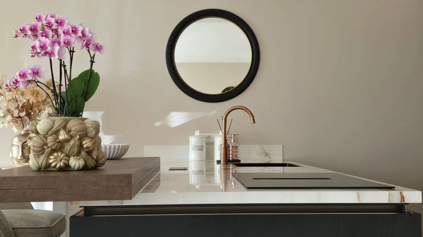 Black kitchen with ceramic worktop and copper tap
