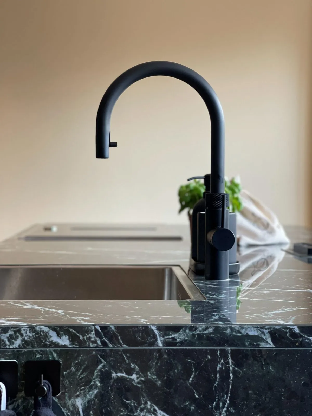 Black tap on green marble